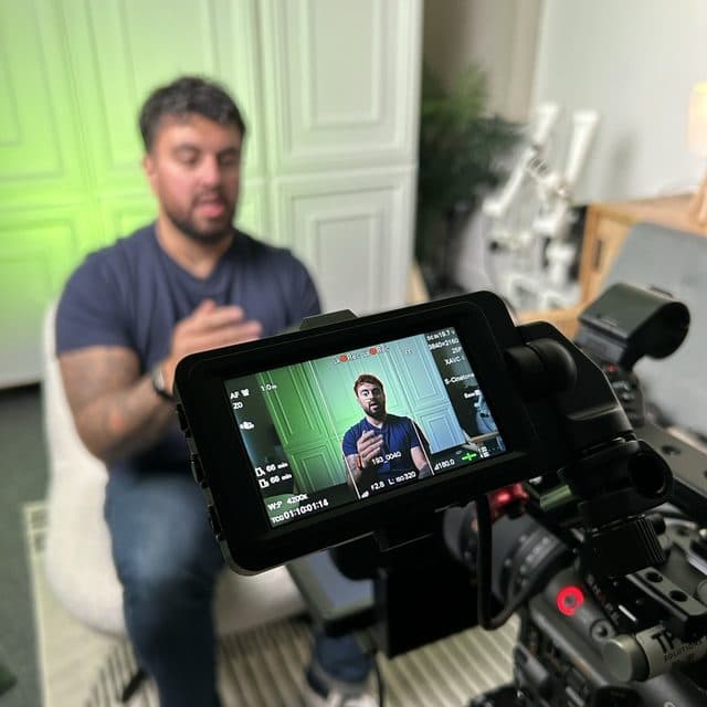 The camera monitor framing a shot in the studio